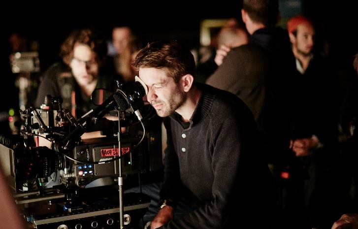 man looking through viewfinder