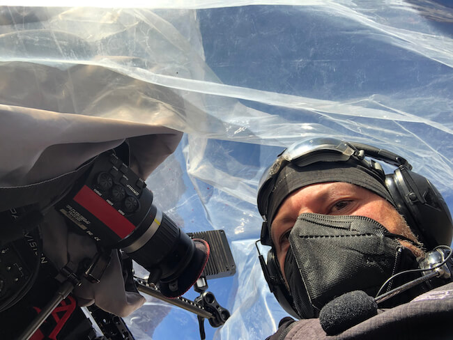 man in mask near camera viewfinder