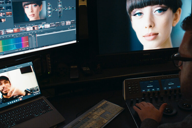 Colorist in suite with client on remote screen